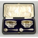 A cased pair of George V silver open salts.