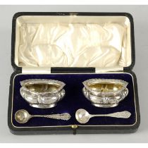 A cased pair of George V silver open salts.