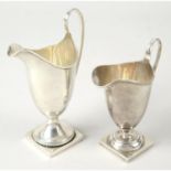 Two early 20th century silver pedestal cream jugs.