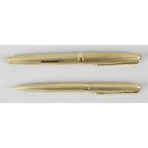 A set of 18ct gold Parker pens.