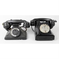 Two Bakelite cased telephones.
