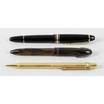 A Montblanc Meisterstuck fountain pen, with a Sheaffers fountain pen and Must de Cartier propelling