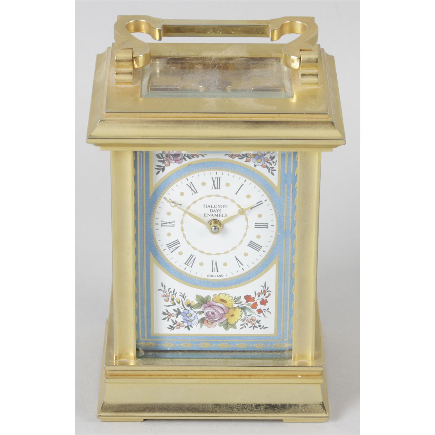 A Halcyon Days Enamel brass carriage clock decorated to the dial with ...