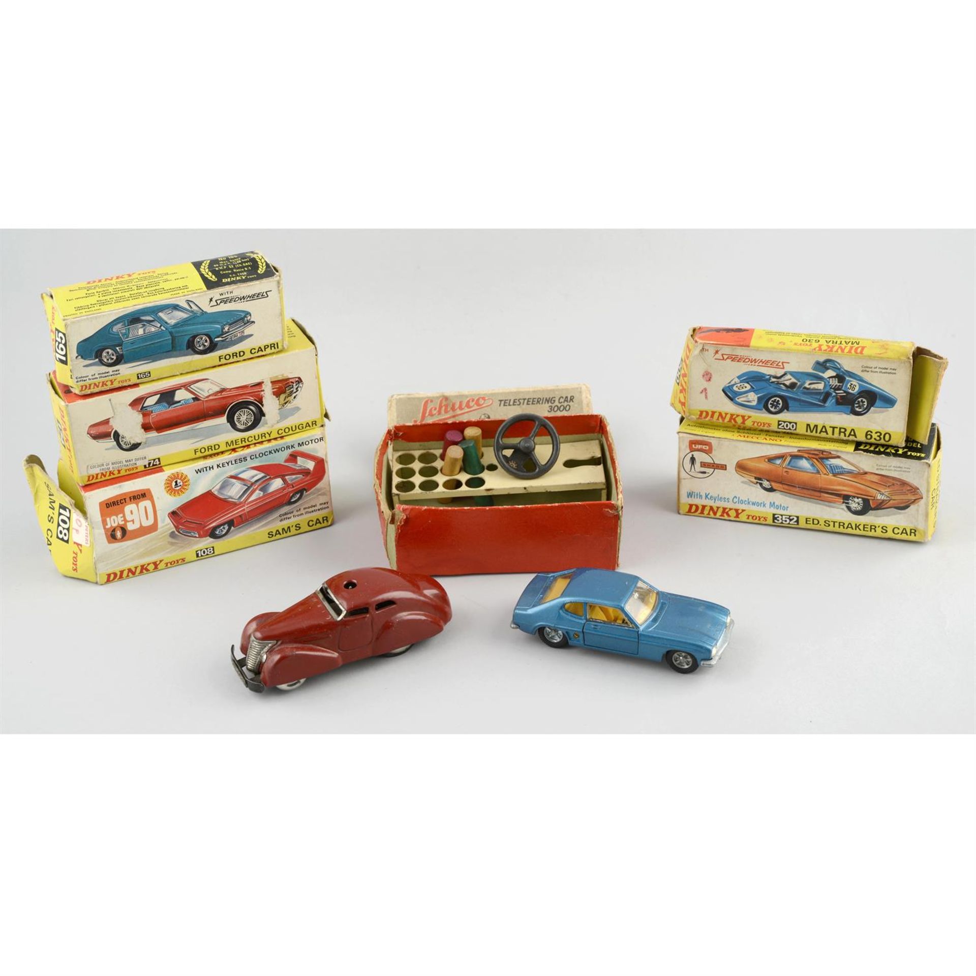 A Schuco telesteering car 3000 and a five boxed Dinky cars