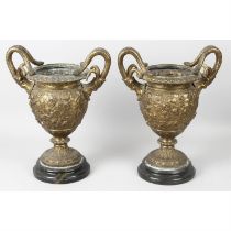 A pair of gilt metal urns