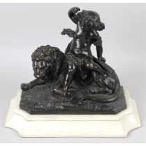 A bronze Cherub upon a lion