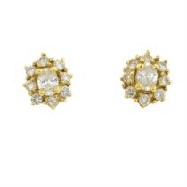 Vari-cut diamond cluster earrings.