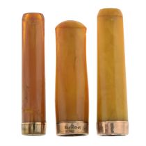 Three early 20th century gold & amber cigarette holders