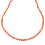 A coral single-strand necklace.