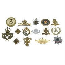 A collection of military cap badges, etc.