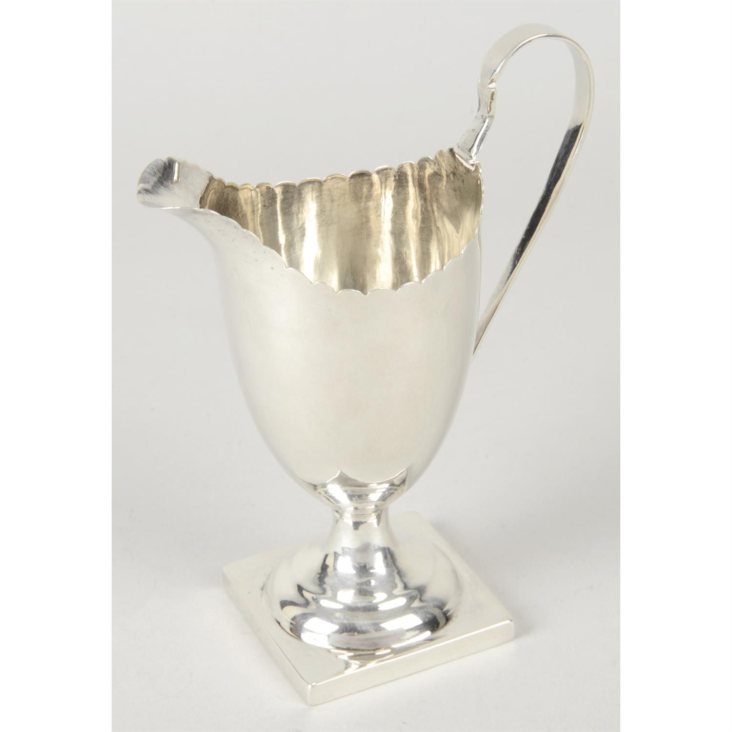 George III silver cream jug with scalloped rim.