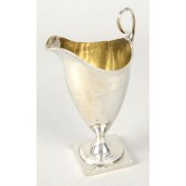 George III silver cream jug with beaded rim.