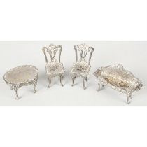 Four modern silver miniature furniture pieces.