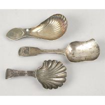 Two Georgian silver caddy spoons & one Victorian example. (3).