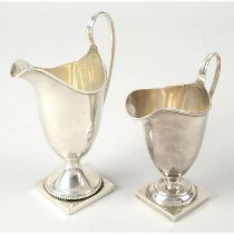 Two early 20th century silver pedestal cream jugs.