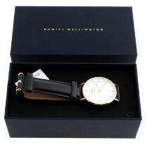 A group of ten boxed Daniel Wellington watches.