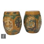 A pair of Chinese Sancai style glazed garden seats, each of rounded barrel form, incised and