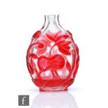 A Chinese red overlay glass snuff bottle, the flattened bottle overlaid in ruby red glass with lotus