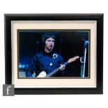 A signed Noel Gallagher framed photograph, the colour photograph signed in black pen, framed and