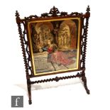 A large Victorian rosewood framed fire screen with applied scrollwork detail, raised to