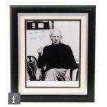 A signed George Martin photograph, the black and white photograph signed in blue ink 'with best