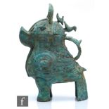 A Chinese archaistic zoomorphic wine vessel (guang), the cast metal vessel raised on tripod