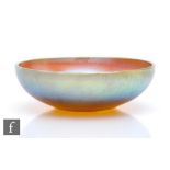 A 1930s WMF Myra Kristal bowl of shallow footed form, decorated with a tonal gold through purple and