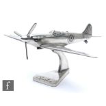 A large 20th century aluminium table or desk model of a Spitfire with revolving propeller, on a