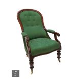 A Victorian mahogany spoon back easy chair on turned legs to the front, upholstered in green