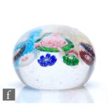 A miniature 19th Century Clichy paperweight with a central rose surrounded by a ring of mixed colour