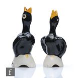 A pair of Clarice Cliff Blackbird pie funnels hand enamelled in black and yellow, one with a later