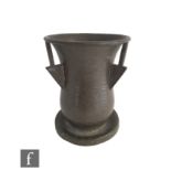 A Liberty & Co. Tudric pewter vase, the spreading circular base, extending to a hammered baluster