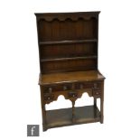 A Titchmarsh and Goodwin oak miniature dresser and rack, model 25A, retailed by Liberty,