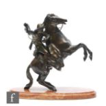 A bronze figure of a cowboy on horseback, in the manner of Frederick Remington, unsigned, mounted to