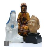 A collection of Asian Buddhistic figures, to include a Chinese glazed figure of Guanyin, height 19.