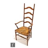 An Arts and Crafts oak ladder back armchair, designed by William Birch for Liberty & Co, with ring