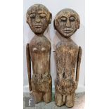 Two naively carved wooden male and female figures, height 64cm and 66cm respectively, S/D. (2)