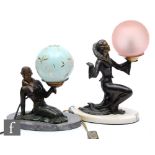 A 20th Century spelter table lamp decorated with a stylish kneeling female figure holding a