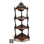A Victorian walnut four tier corner what-not, with line inlaid detail and fret-cut gallery to the
