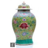 A Chinese late 19th/early 20th Century famille rose jar and cover of baluster form surmounted by a