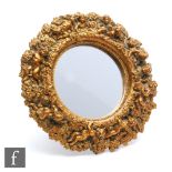 A small 20th Century moulded gilt framed easel mirror decorated with winged cherubs amidst