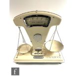 A set of 1950s cream painted enamelled Avery grocer's scales, model 505, width 48cm.