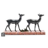 A 20th Century patinated spelter figure of two stylised standing fawns, mounted to a rectangular