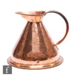 A large 19th Century copper harvest jug of tapering form and stepped circular base, height 32cm.