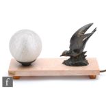 An Art Deco style table lamp, the marble base mounted with a sphere and a bird, width 37.5cm.