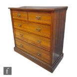 A late 19th Century walnut straight front chest of two short over three long drawers, with ribbed
