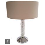 A contemporary Lalique table lamp titled Faunes, the chromed conical base mounted with a clear
