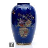 An early 20th Century Carlton Ware vase of footed baluster form decorated in a Chinoiserie design