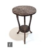 A Liberty & Co Aesthetic style foliate carved softwood occasional table of circular form, raised