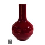 A Chinese sang de boeuf glazed bottle vase, the rounded globular body rising to a cylindrical